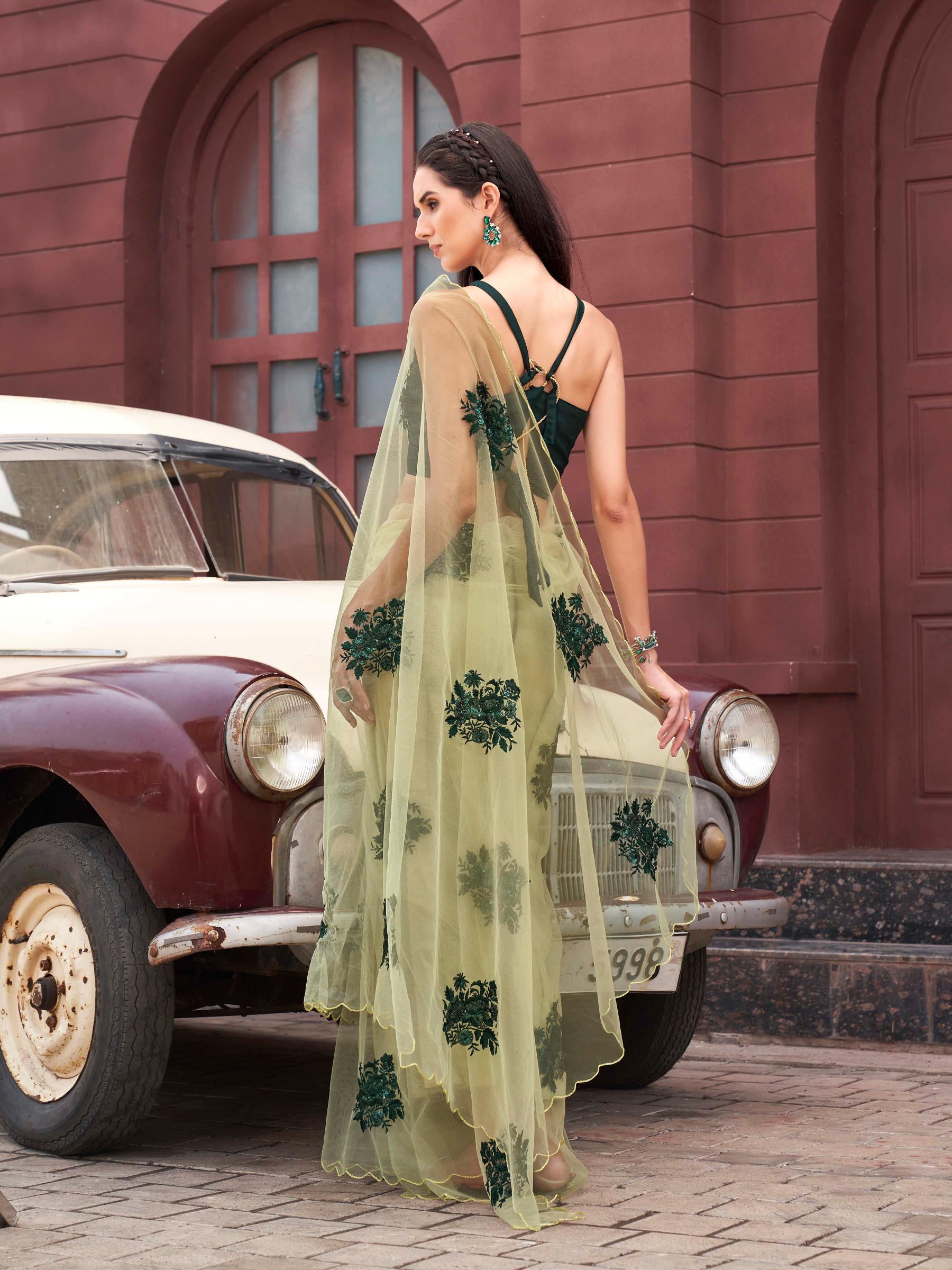 Green colored embroidered net saree with scalloped border